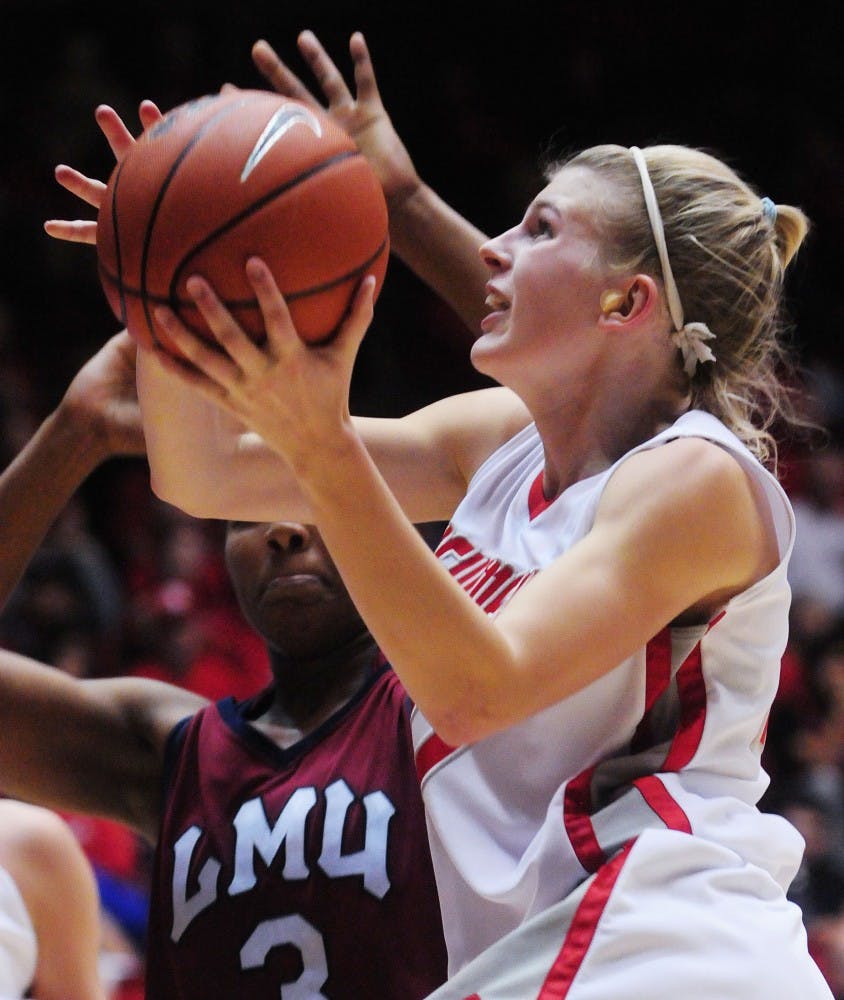 	Lauren Taylor drives past Loyola Marymount’s Alex Cowling during the Lobos’ 74-55 victory over the Lions on Saturday at The Pit. Taylor had 20 points on Saturday, marking the third time she scored at least 20 points in the last four games.