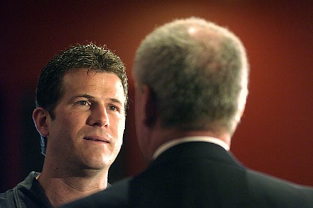 Men's basketball head coach Steve Alford speaks with Athletics Director Paul Krebs after a news conference Monday at the Davalos Center. Krebs announced that Alford signed a three-year extension, which will keep him at UNM through the 2015-16 season.