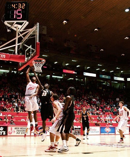 A.J. Hardeman dunks over Grambling State's George Akpele on Thursday at The Pit, as the Lobos waxed the Tigers 96-50. Hardeman had 10 points in 19 minutes. 