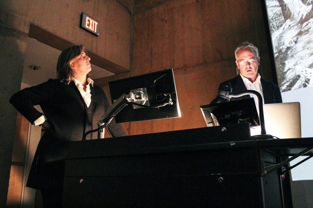 Hadley Arnold (left) and Peter Arnold discuss methods of water conservation Friday afternoon at George Pearl hall.They are both part of the Arid Lands Institute.