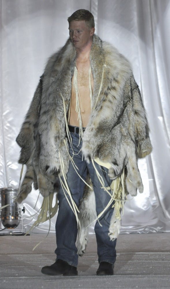 A model walks down the runway during Saturdays Albuquerque Fashion Week Show in Albuquerque Convention Center. The second annual New Mexico Fashion Week Runway Show sought to promote local designers, businesses, manufacturers and other aspects of the fashion industry.