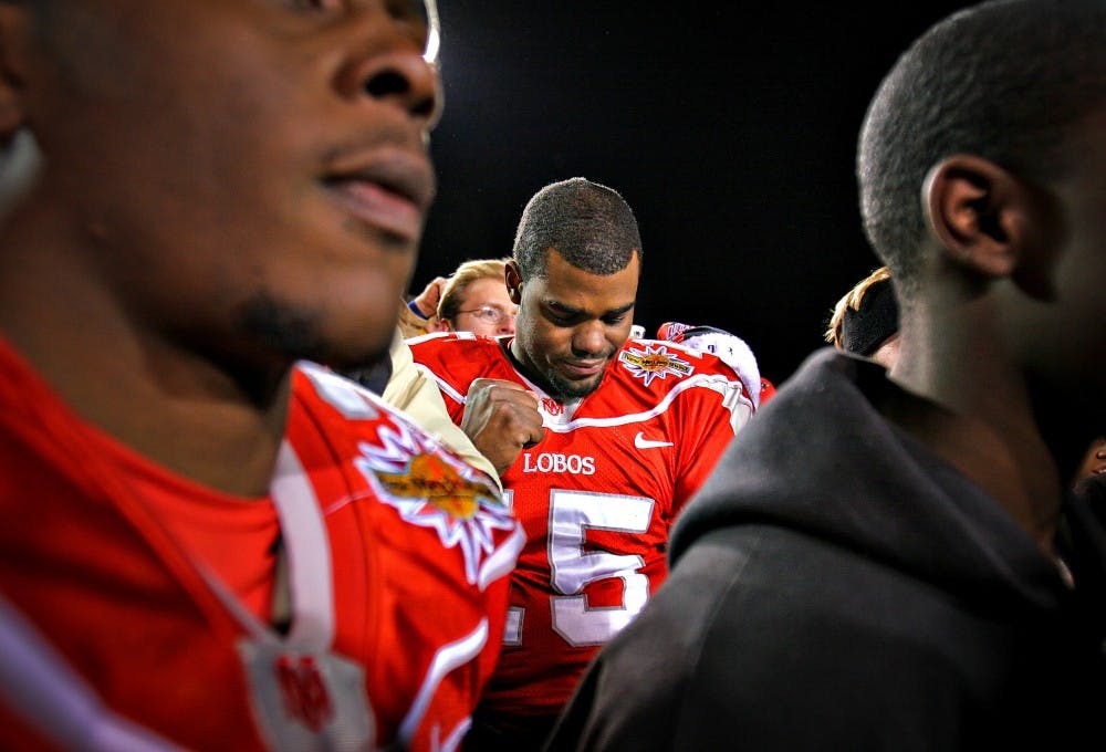 UNM quarterback Donovan Porterie quietly celebrates among a crowd in the middle of the field after the Lobos won the New Mexico Bowl on Dec. 22 at University Stadium. UNM beat Nevada 23-0.