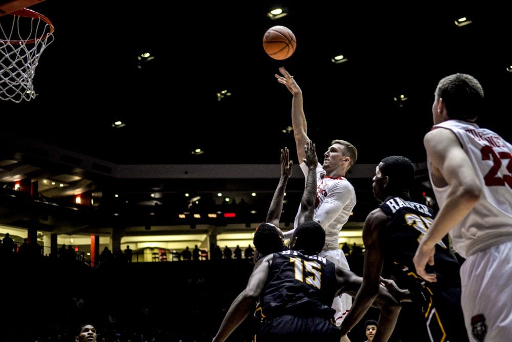 Redshirt sophomore forward Connor MacDougall towers over Arkansas-Pine Bluff defensemen during their game Saturday, Dec. 17, 2016 at WisePies Arena. The Lobos faced off with the San Diego State Aztecs this past Sunday and defeated them 68-62.&nbsp;