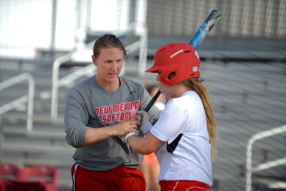 Assistant softball coach Shelby Pendley directs a player on how to grip a bat at the Lobo Softball Field Wednesday afternoon. Pendley, along with Jessica Garcia, are former Lobos hired as coaches following the departure of Lisa-Ann Wallace.