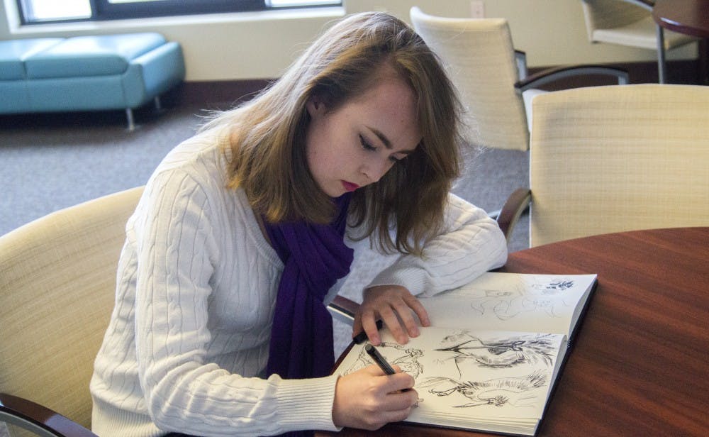 Camber Arnhart, a freshman Computer Science major, draws in her sketch book Monday afternoon in Hokona Hall.&nbsp;Amhart was one of three winners of the&nbsp;L. Ron Hubbard Writers and Illustrators of the Future Contest.&nbsp;