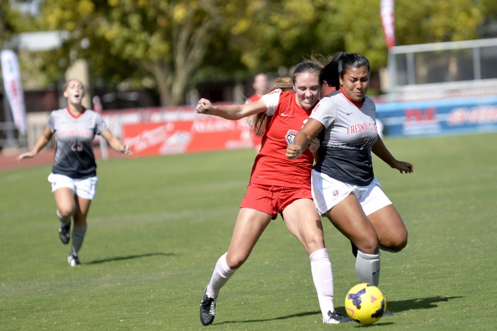 Forward Madisyn Olguin battles with Fresno State's Alyssa Cruz for the ball on Sunday at the UNM Soccer Complex. The Lobos won the game 5-1.