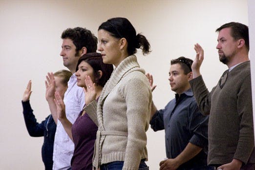Participants in a mock trial hosted by the UNM School of Law take an oath Saturday at the Second Judicial District Court. Students preparing for a career as litigators acted as defense and prosecution attorneys at the mock trials.