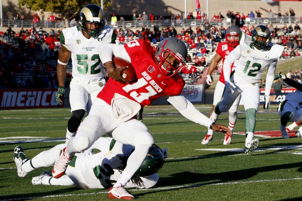 Red Shirt Sophomore quarterback&nbsp;Lamar Jordan&nbsp;drives through CSU's defense at University Stadium Saturday afternoon. The Lobos lost against CSU 28-21.&nbsp;