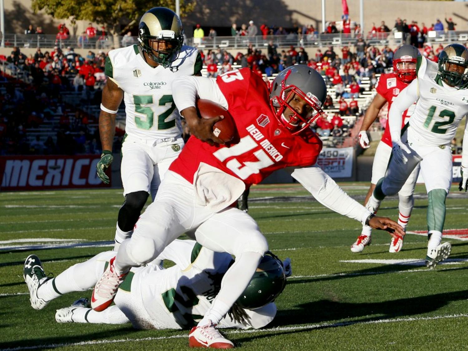 Red Shirt Sophomore quarterback Lamar Jordan drives through CSU's defense at University Stadium Saturday afternoon. The Lobos lost against CSU 28-21. 