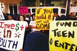 Members of SouthWest Organizing Project rally at the City Council Chambers in support of a Downtown teen facility on May 17.