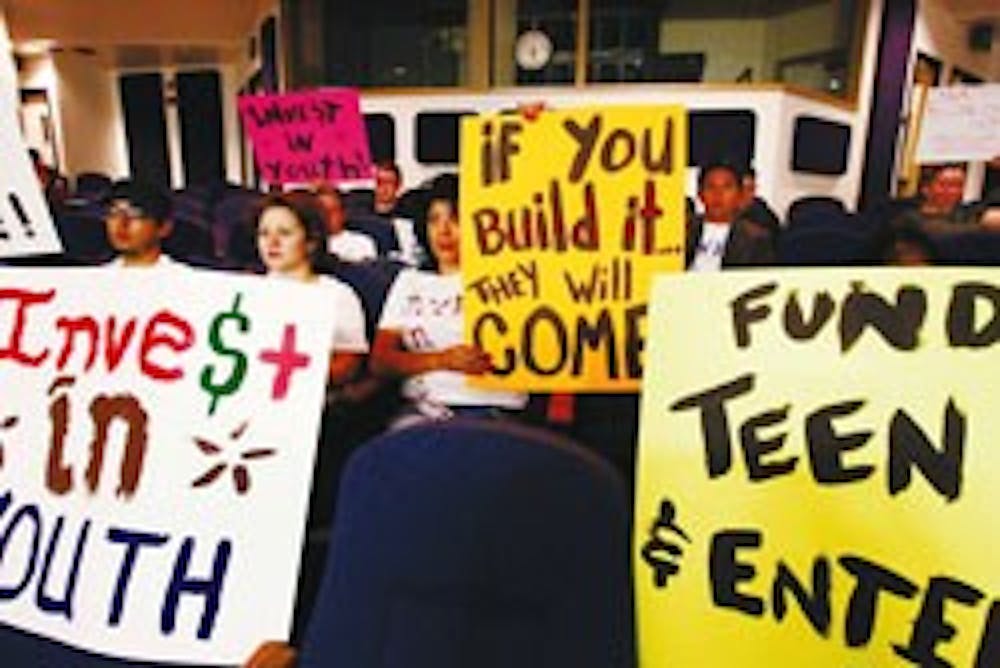 Members of SouthWest Organizing Project rally at the City Council Chambers in support of a Downtown teen facility on May 17.