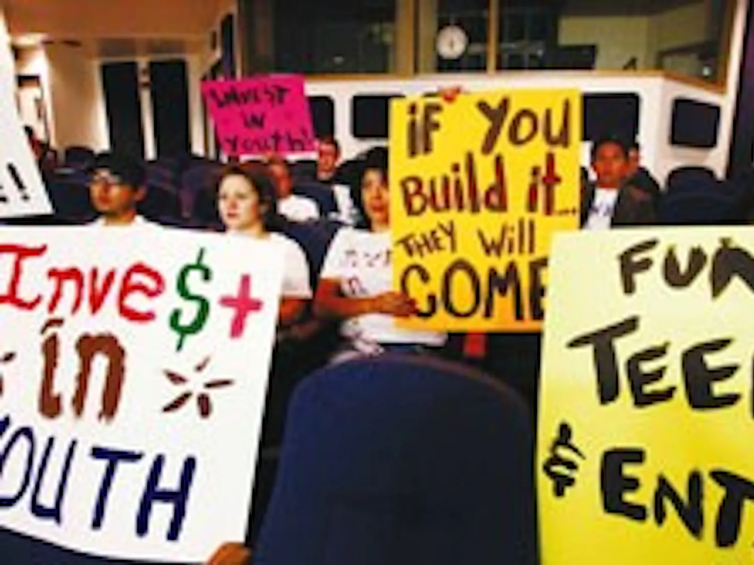 Members of SouthWest Organizing Project rally at the City Council Chambers in support of a Downtown teen facility on May 17.