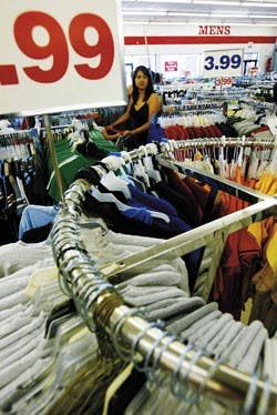 Nivid Aguilar shops at Fallas Paredes, a discount clothing outlet on the West Side, on Sunday.