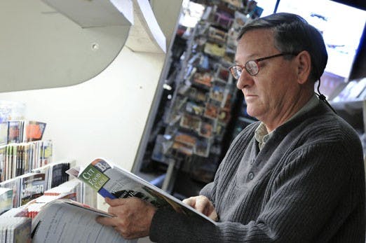 Chris West looks at a magazine at Newsland Bookstore, a magazine and newspaper shop on Central Avenue.