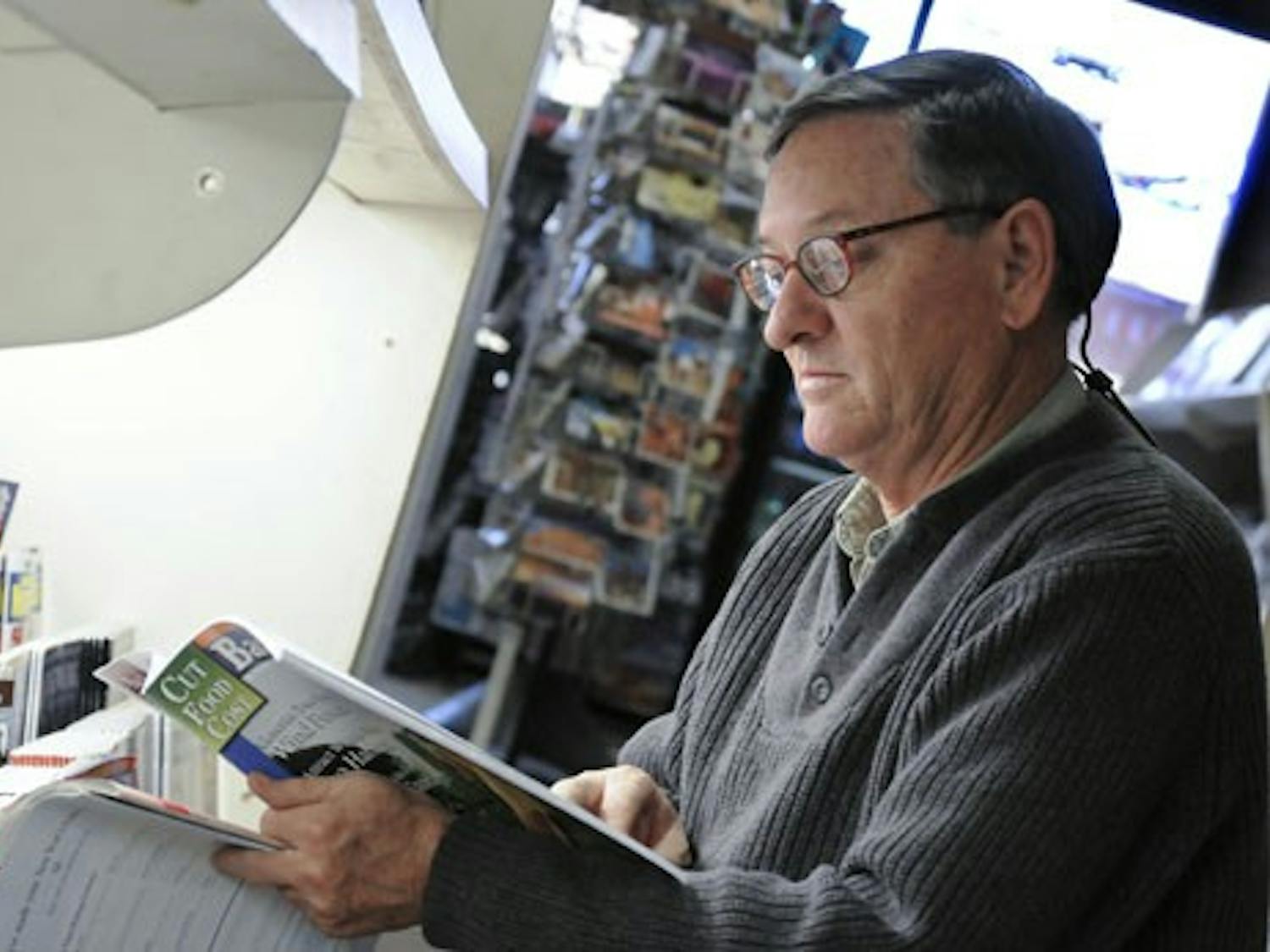 Chris West looks at a magazine at Newsland Bookstore, a magazine and newspaper shop on Central Avenue.