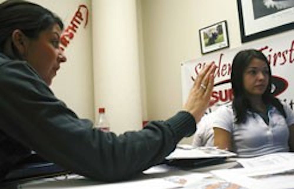 ASUNM President Brittany Jaeger, left, talks with Erin Muffoletto, ASUNM's lobby director, in the SUB while making labels Thursday in preparation for UNM Day at the Legislature in Santa Fe on Friday.