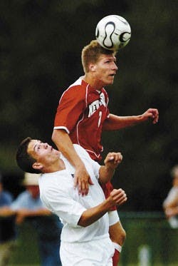 Michigan State's Doug DeMartin, bottom, loses a battle for the ball to Lobo freshman defender Justin Davis during Friday's game in East Lansing, Mich.  