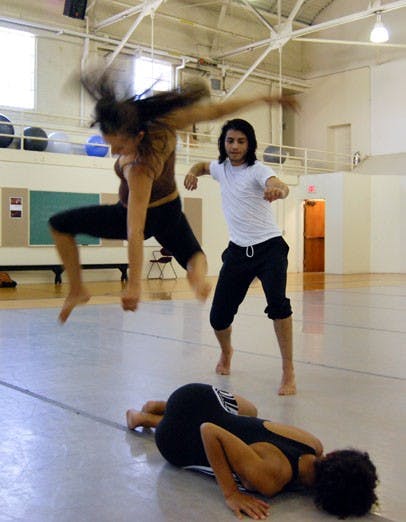 Gabi Rojas, bottom, Crystal Fernandez and Estaban Garza rehearse "Muevete" in Carlisle Gym on Tuesday. 