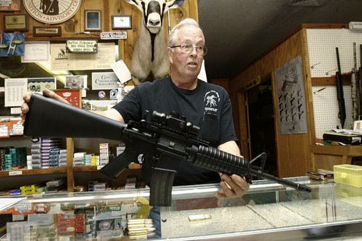 Jerry Ellenberger, owner of Los Ranchos Gun Shop, displays an AR-15 semiautomatic rifle Tuesday. UNMPD has trained some of its officers to use the weapons in the event of a shooting on campus.