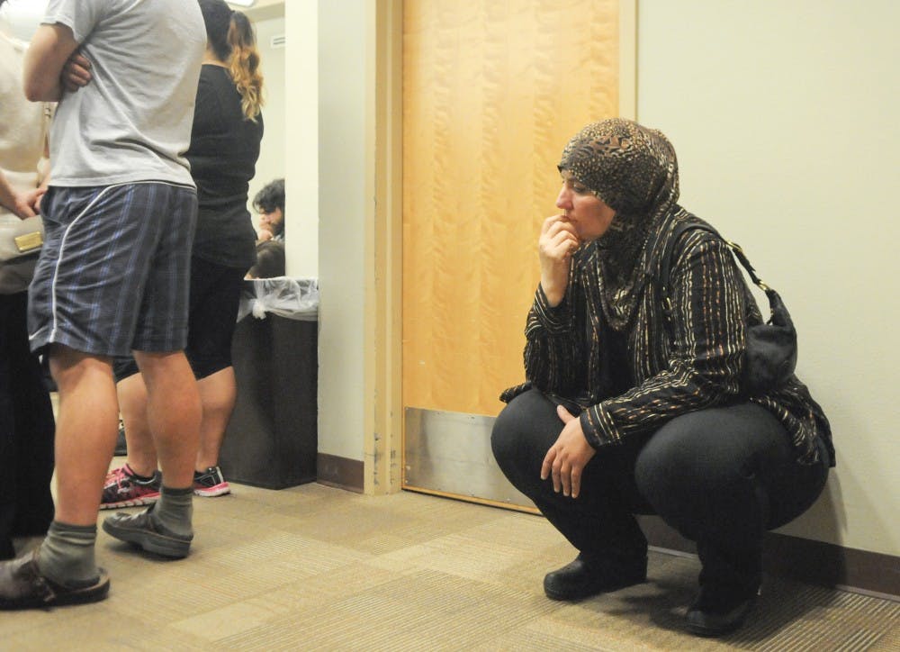 Sandra Akkad, an elementary education graduate, student listens an ASUNM senators discussion about Resolution 12S. If it had passed, the resolution would have asked UNM to be transparent with its investments.