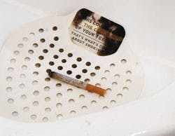 A urinal strainer in Dane Smith Hall displays an anti-smoking message. Students placed the urinal strainers around campus restrooms to present the aesthetic effects of smoking.