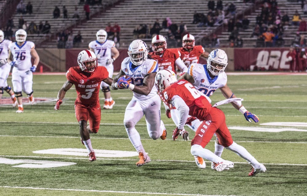 Boise State running back Alexander Mattison runs during the second quarter of the game at Dreamstyle Stadium as UNM cornerbacks De’John Rogers and D’Angelo Ross pursue. The Broncos won 45-14 in November 2018. UNM is in negotiations for a new manager of its media rights after terminating its contract with Learfield Communications in June 2019.&nbsp;