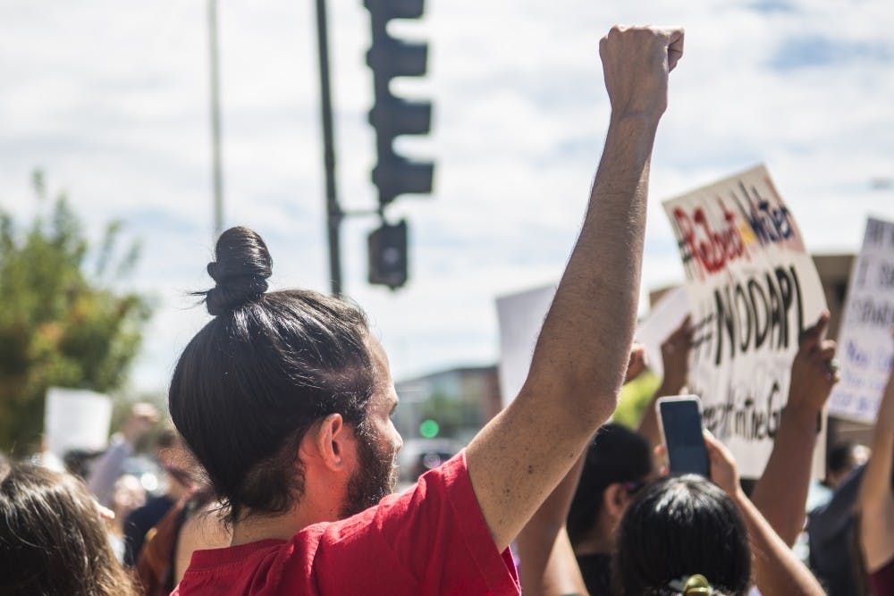 Protestors stand together against the Dakota Access Pipeline at the University of New Mexico Thursday, Sept. 8, 2016.