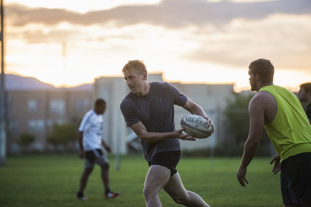 UNM rugby players run drills in the early morning on Monday, Sept. 14, 2015 on Johnson Field. ASUNM has passed legislation to recognize and fund both women’s and men’s rugby.