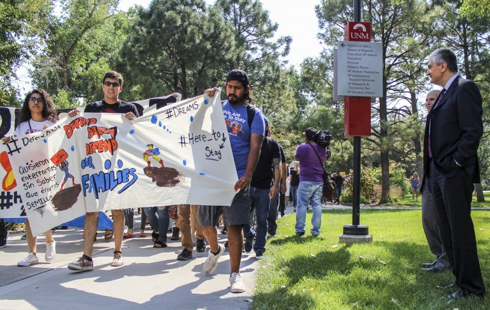 DACA supporters march past UNM interim President Chaouki Abdalluh on Sept. 6, 2017. President Abdullah and Chancellor for Health Sciences, Dr. Paul Roth, showed their support by addressing DACA supporters outside of Scholl?s Hall.  
