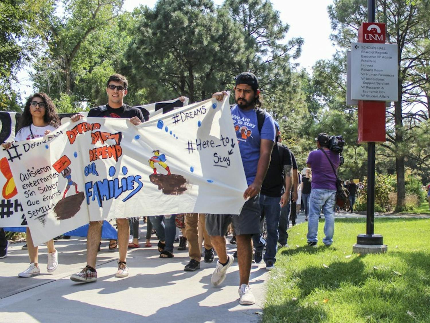 DACA supporters march past UNM interim President Chaouki Abdalluh on Sept. 6, 2017. President Abdullah and Chancellor for Health Sciences, Dr. Paul Roth, showed their support by addressing DACA supporters outside of Scholl?s Hall.