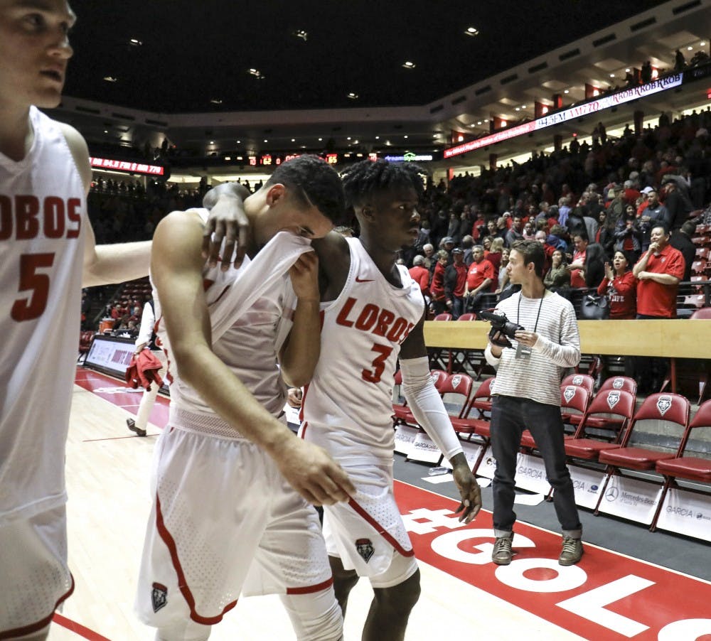 Joe Furstinger, #5, and Antino Jackson, #3 comfort their fellow teammate after their loss against NMSU at Dreamstyle Arena on Dec. 09, 2017.  The Lobos lost 65-62