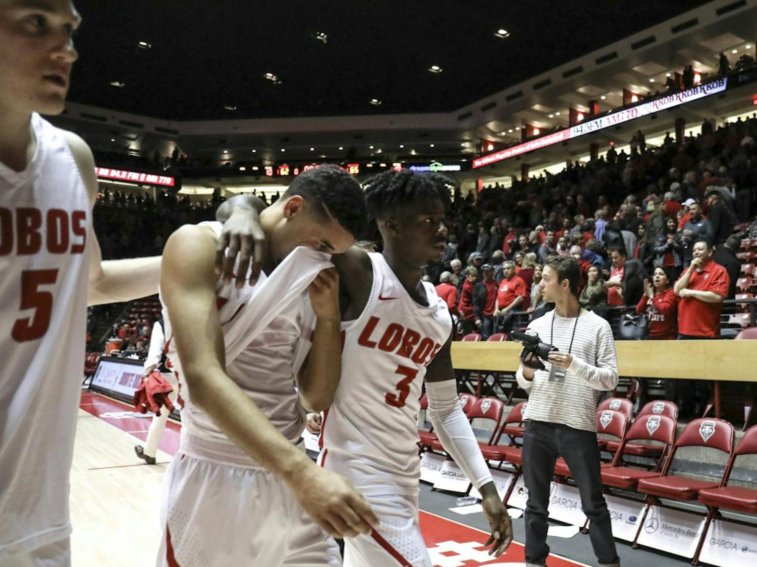 Joe Furstinger, #5, and Antino Jackson, #3 comfort their fellow teammate after their loss against NMSU at Dreamstyle Arena on Dec. 09, 2017. The Lobos lost 65-62