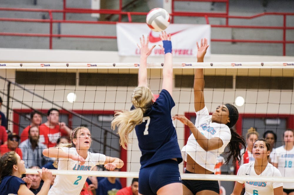 Lobos Simone Henderson reaches above the net to block a Nevada players attack during their game September 26, 2015. The Lobos are expected to play Colorado State October 8. 