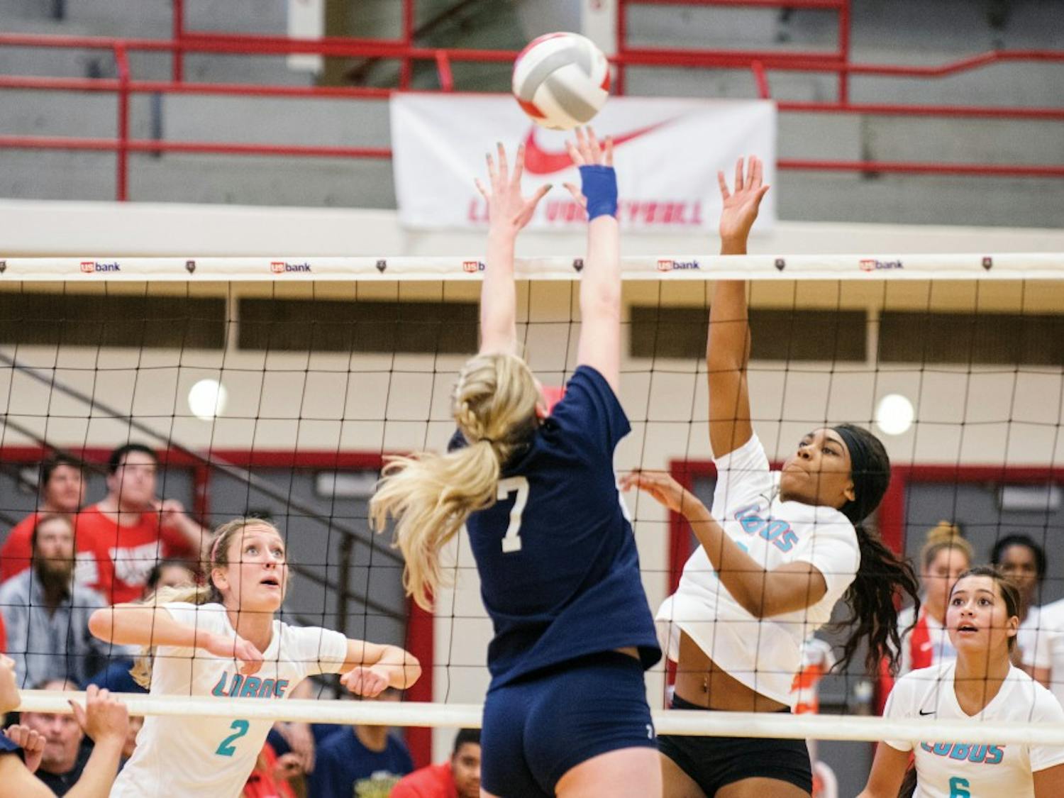 Lobos Simone Henderson reaches above the net to block a Nevada players attack during their game September 26, 2015. The Lobos are expected to play Colorado State October 8. 