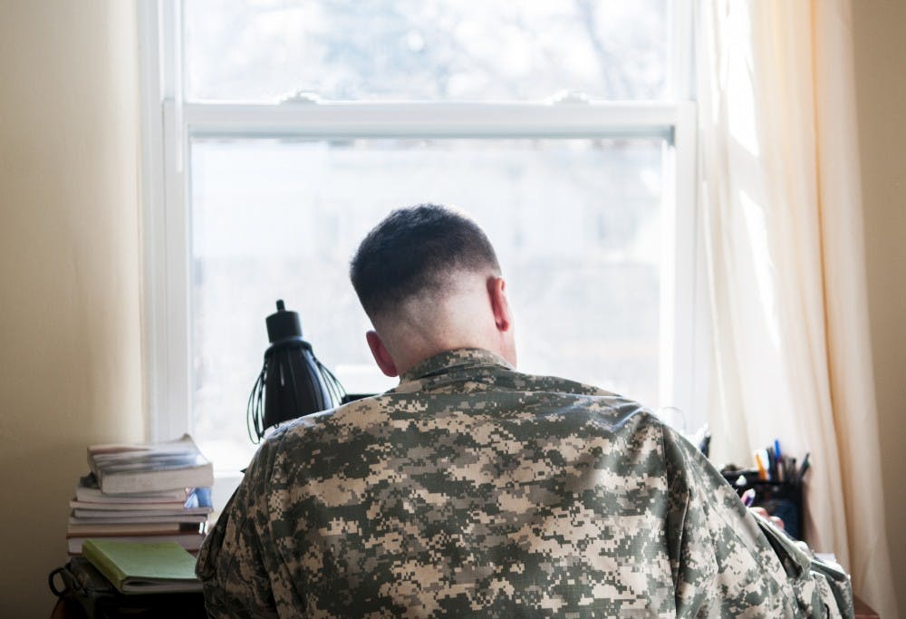 David Dobbs, a U.S. Army veteran who has served three tours in Afghanistan, studies at his home in Albuquerque on Wednesday evening. Dobbs is a graduate student studying public administration, and he utilizes UNM's Green to Gold program to get through school.&nbsp;