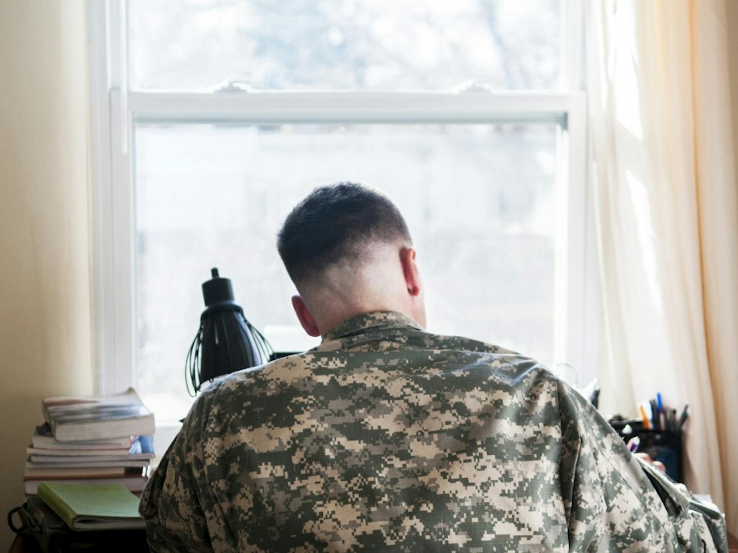 David Dobbs, a U.S. Army veteran who has served three tours in Afghanistan, studies at his home in Albuquerque on Wednesday evening. Dobbs is a graduate student studying public administration, and he utilizes UNM's Green to Gold program to get through school.&nbsp;