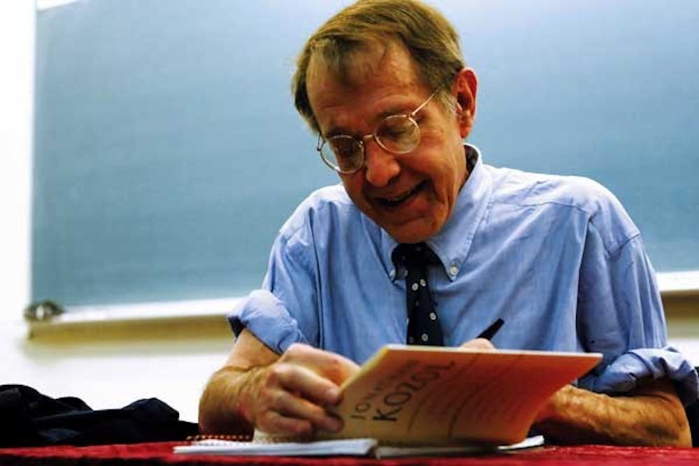 Jonathan Kozol signs his book Letters to a Young Teacher on Tuesday in Woodward Hall. 