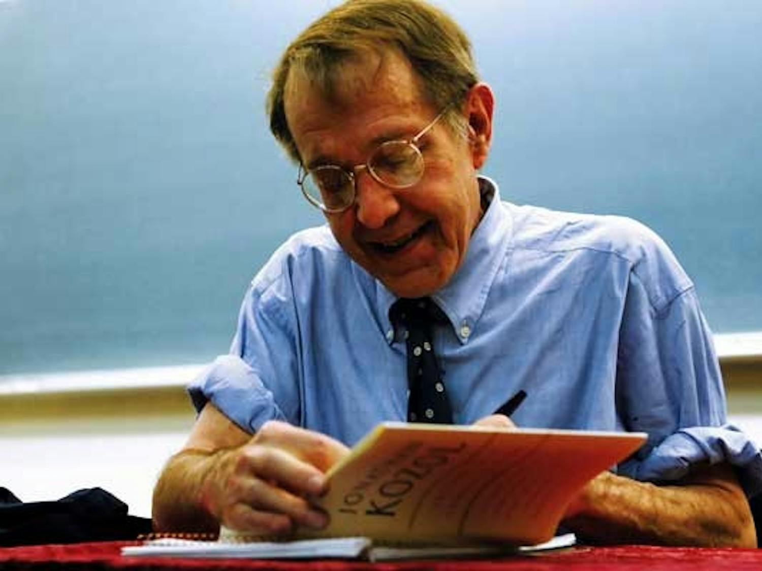 Jonathan Kozol signs his book Letters to a Young Teacher on Tuesday in Woodward Hall.