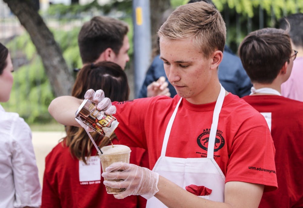 A UNM ROTC student makes a&nbsp;rootbeer float during&nbsp;UNM President Garnett Stokes&nbsp;rootbeer float open house on April 12, 2018.