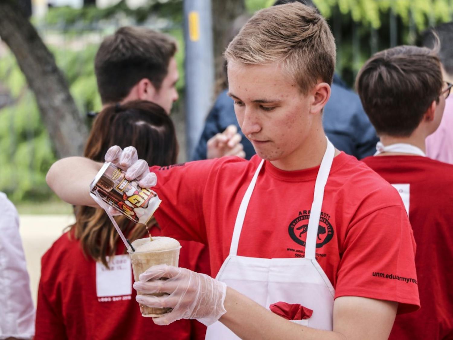 A UNM ROTC student makes a rootbeer float during UNM President Garnett Stokes rootbeer float open house on April 12, 2018.