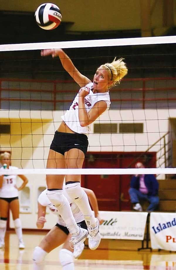 UNM's Lisa Meeter spikes the ball during Saturday's match against Utah at Johnson Gym. The Lobos lost 3-1. 