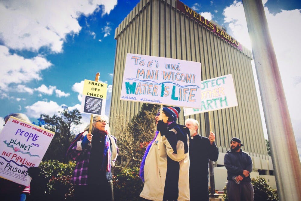 Demonstrators march and chant in front of the Wells Fargo bank in downtown Albuquerque Tuesday, Jan. 25, 2017.&nbsp;&nbsp;