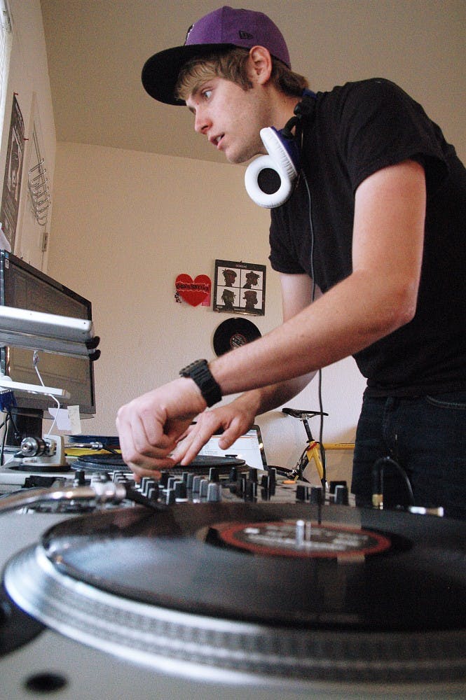 	DJ JurusDiction, a.k.a. Bryan Jurus, mixes tracks in his apartment Monday.