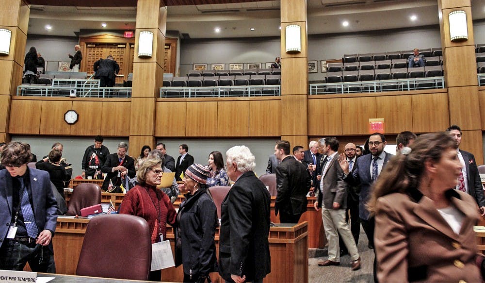 Legislators, reporters, photographers and the public mingle and mumble as they make their way out of the Senate Chamber at the Santa Fe Roundhouse on Feb. 15, 2018. Senators chose not to move forward that morning with a bill that could have given Lottery Scholarship recipients more aid each year.
