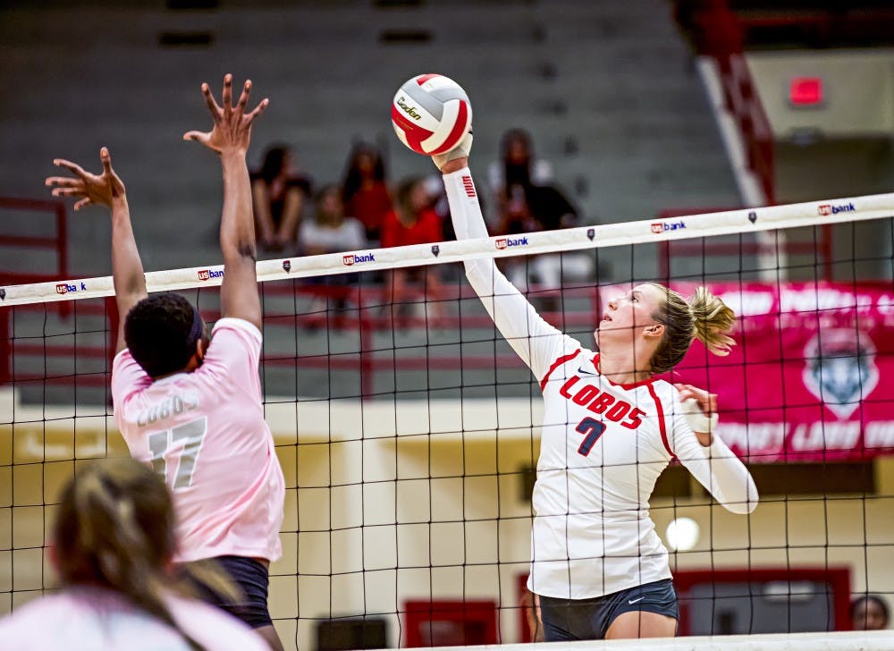 Victoria Spragg attempts a spike over UNM Alumni Skye Gullat (17) on Saturday, August 20th at the Johnson Center.