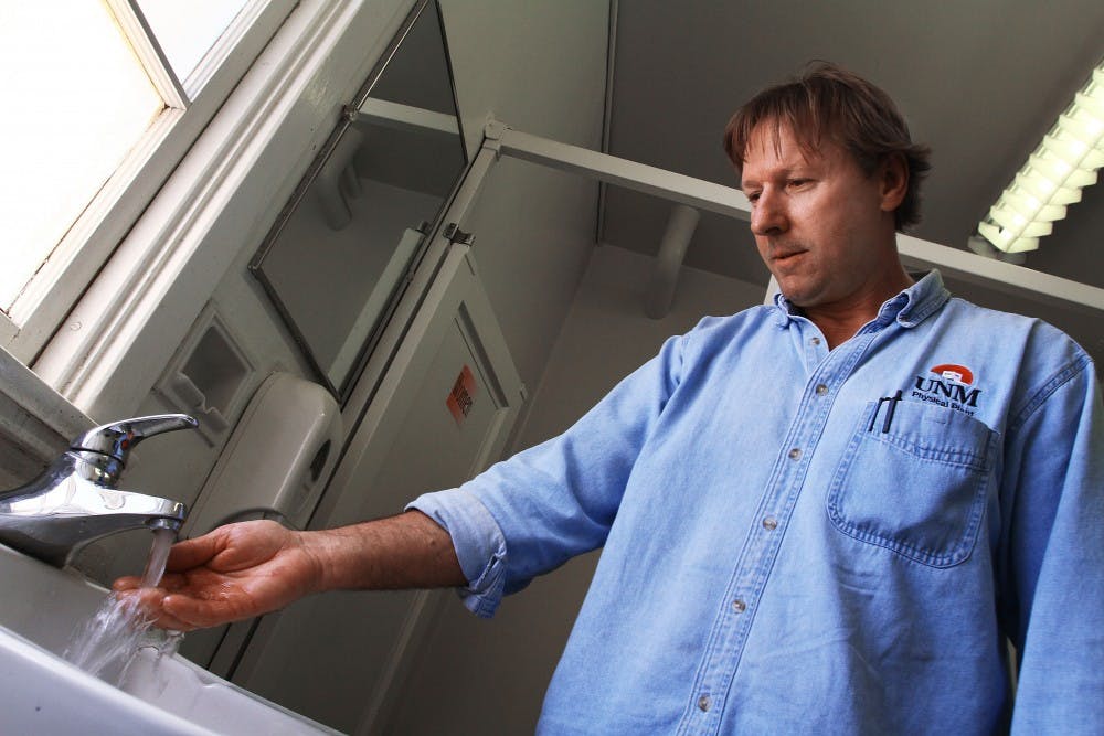 	Kirk Kadas, a Physical Plant Department employee, checks the water in a Marron Hall bathroom on Tuesday. PPD o cials warned students not to drink tap water on campus Tuesday after an
employee noticed discolored water. Full water services should be available throughout campus this morning.