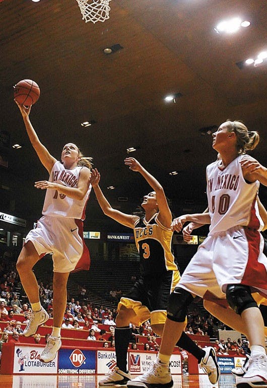 UNM guard Katie Montgomery, left, goes for a lay up after dribbling past University of Colorado-Colorado Springs' guard Dolly Fiedelman during New Mexico's 68-34 win at The Pit on Sunday. 