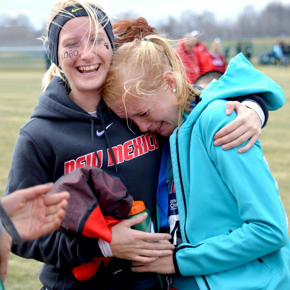 New Mexico senior Charlotte Arter, right, hugs senior Chloe Anderson after the 2014 NCAA Division I Cross Country Championship in Terre Haute, Indiana on Saturday. Arter finished with a time of 20:29.9. 