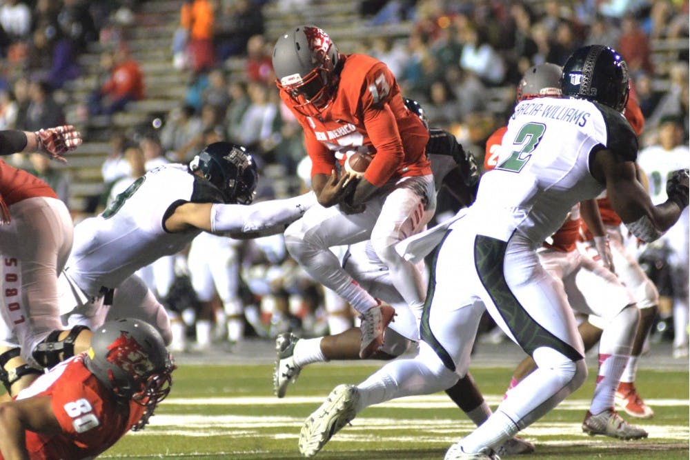 Sophomore quarterback Lamar Jordan (13) leaps away from the Hawaii defensive line at University Stadium on Saturday. The Lobos will play the San Jose State Spartans this Saturday in San Jose, California.