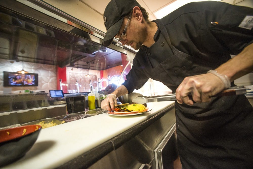 Mazaya Care chef Eric Nicks prepares a plate for customers Saturday, Jan. 14, 2017.